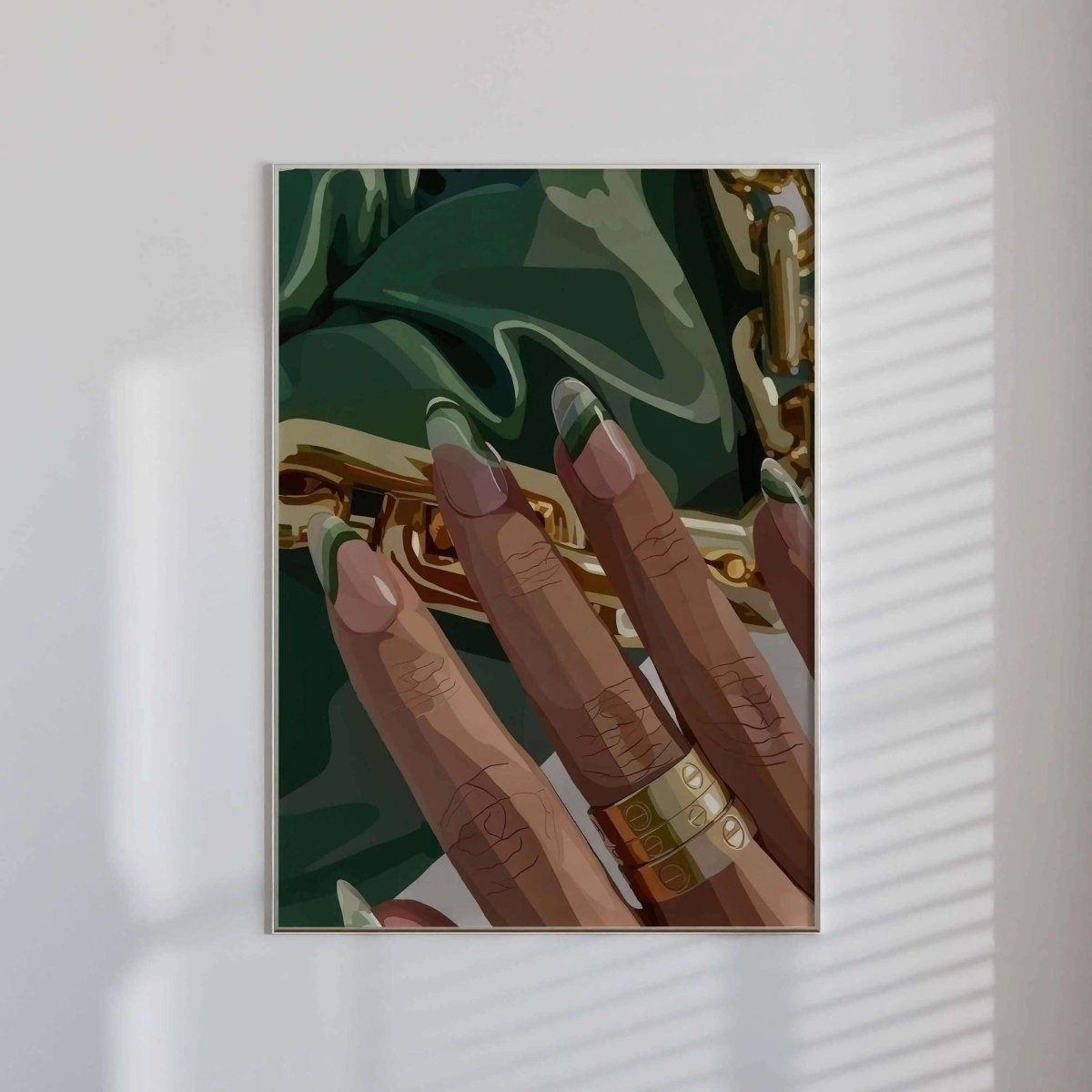 Detailed digital wall art print of a Black woman's hand with gold rings and green nails against fabric, modern home decor, Haus of Prints.
