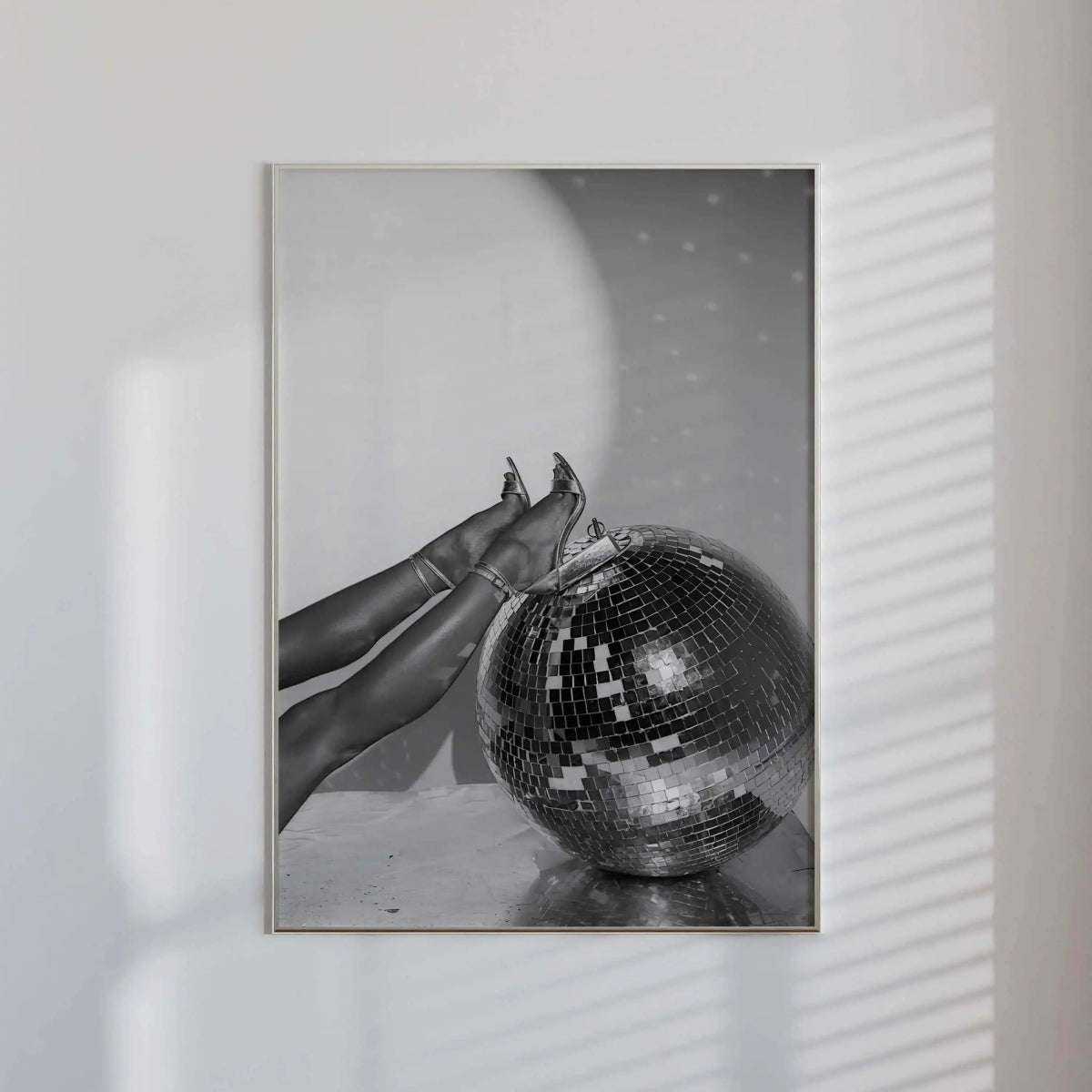 A close-up of shiny lip jewelry contrasting against glossy lips in black and white.