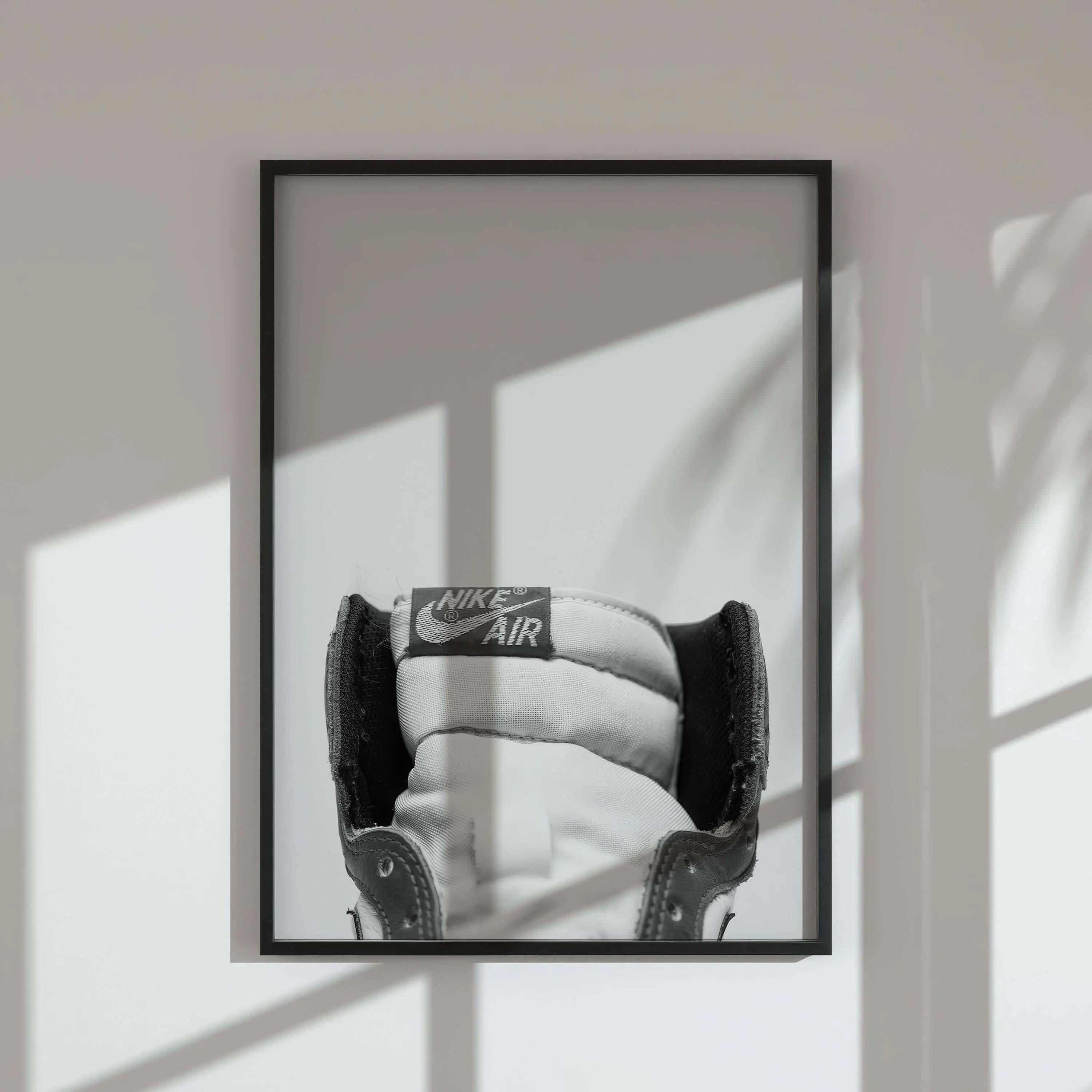Black and white artistic poster of sneakers, featuring a unique aerial perspective.