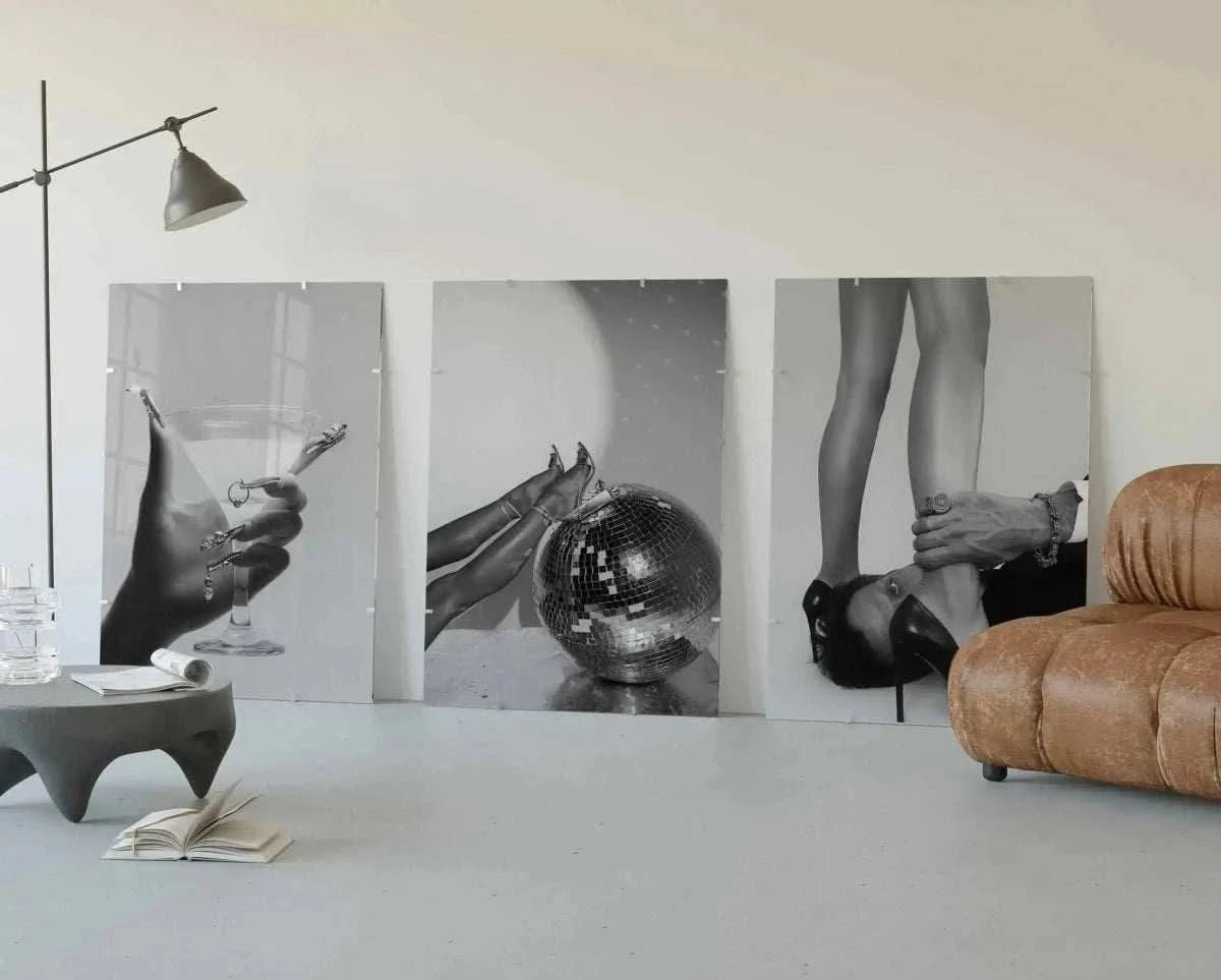 Artwork showcasing stylish legs and high heels resting on a disco ball, ideal for chic wall decor.