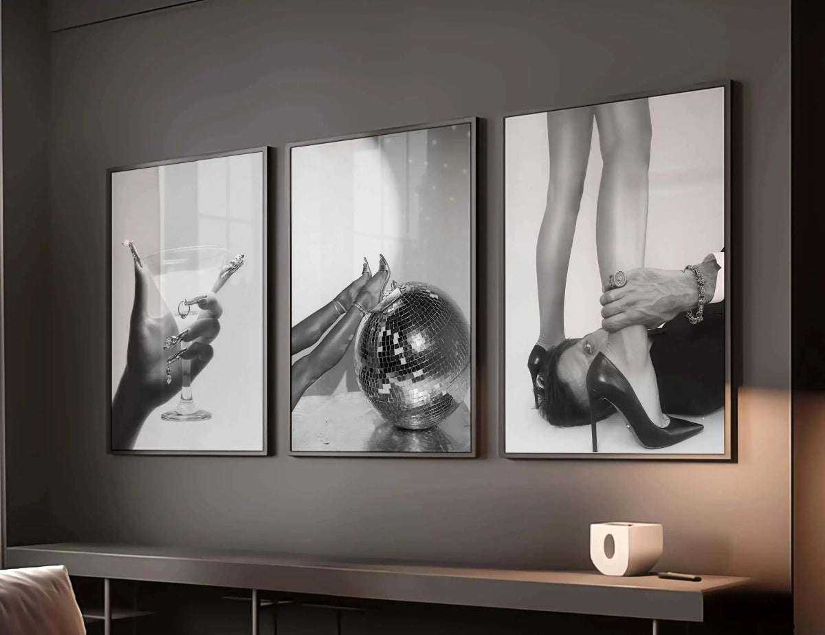 Close-up of an elegant hand with rings holding a martini glass, perfect for stylish interior decor.