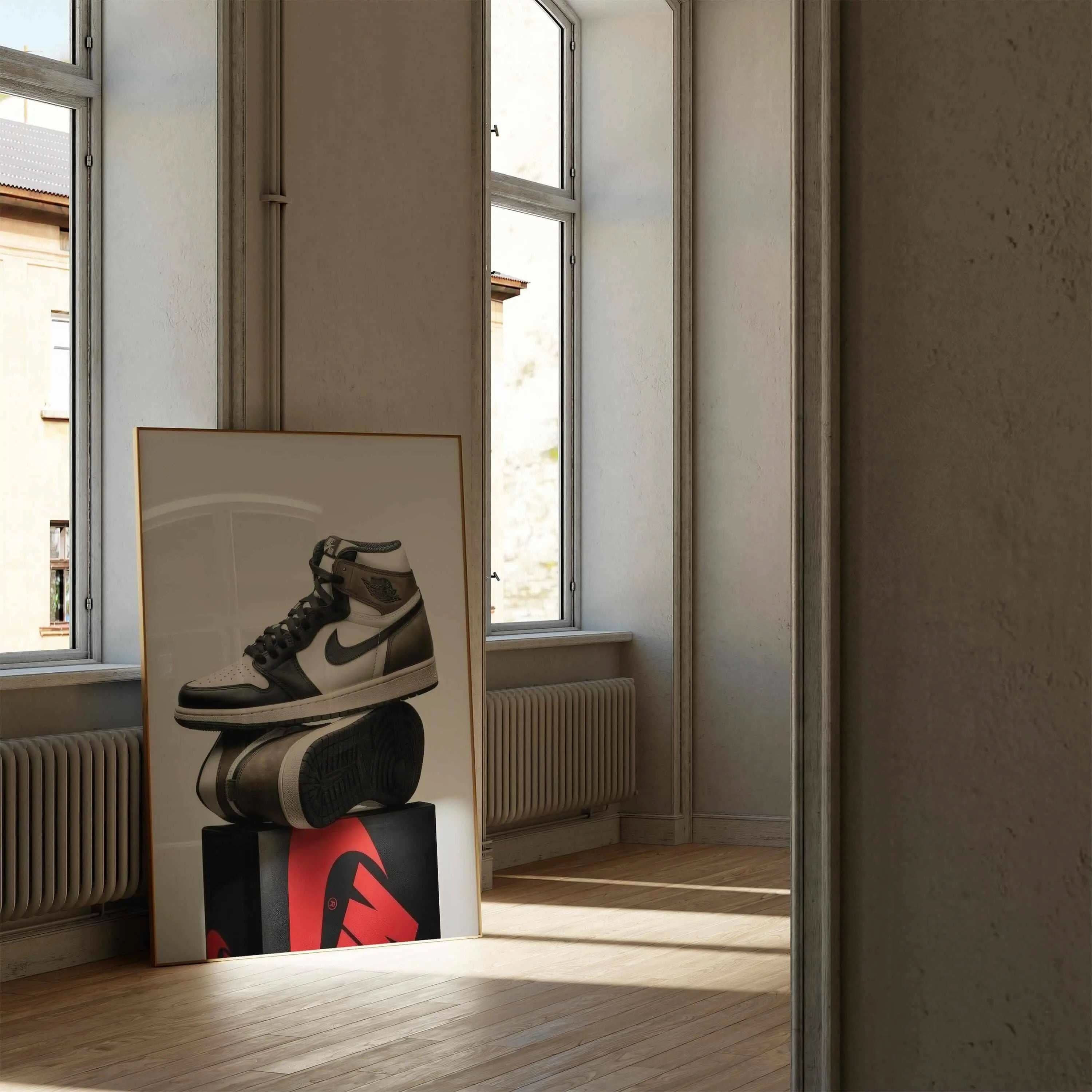 Elegant wall art of trendy sneakers resting on a prominent red and black box.