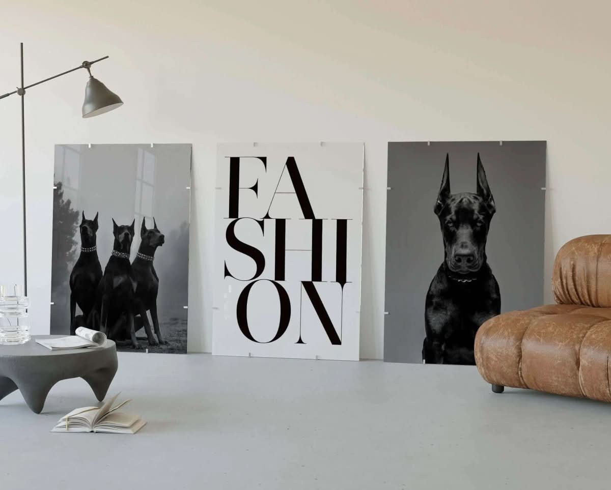 Bold black-and-white poster of three Doberman dogs, symbolizing strength and elegance.