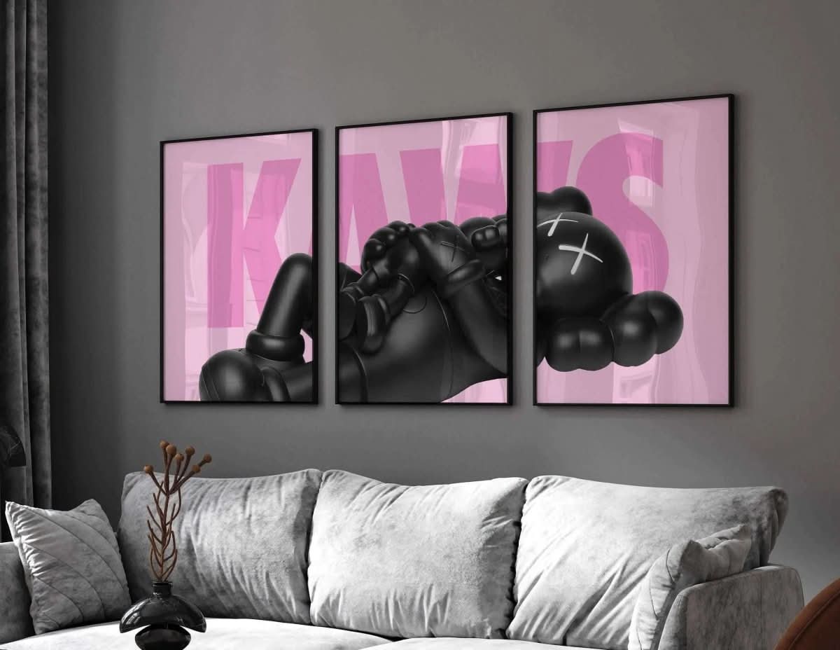 KAWS poster layout showing black figure on a pink backdrop, featuring the full "KAWS" text graphic arrangement.