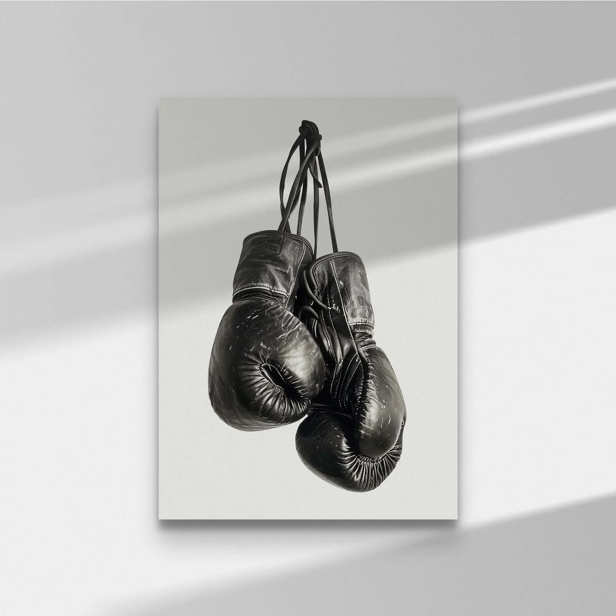 Vintage Boxing Gloves Wall Art featuring two black gloves hanging, perfect for modern decor in any space.