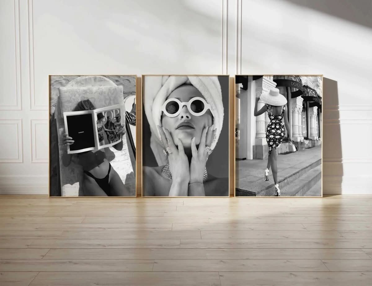 Vintage fashion photography prints set of 3 in black and white, framed art displayed on hardwood floor, modern living room by Haus of Prints.