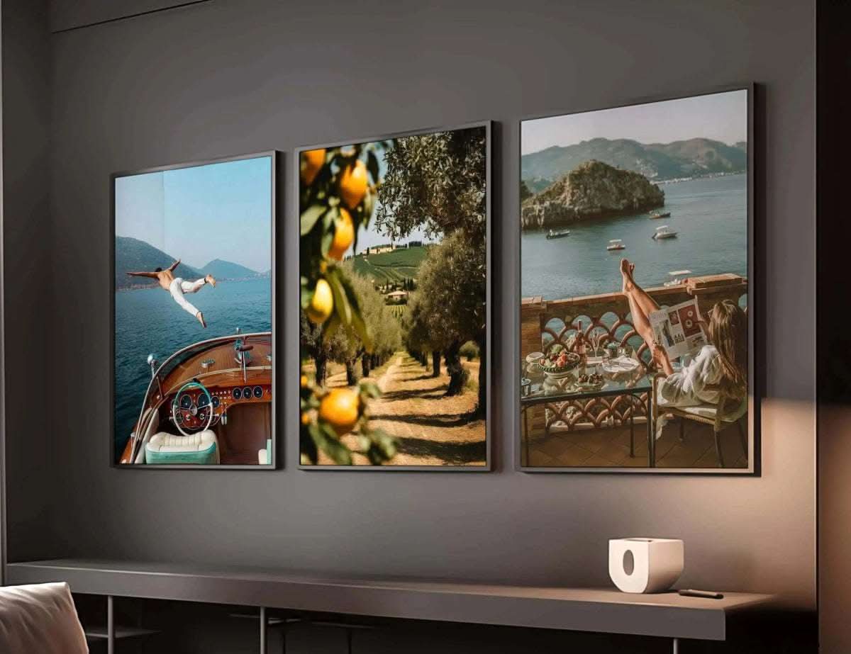 Vintage Seascape Prints Set of 3 displaying a woman relaxing on a balcony with fruits and a magazine by the sea.