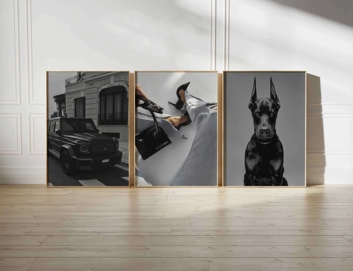 Black G-Class vehicle parked on a stylish street, captured in rich monochromatic tones.