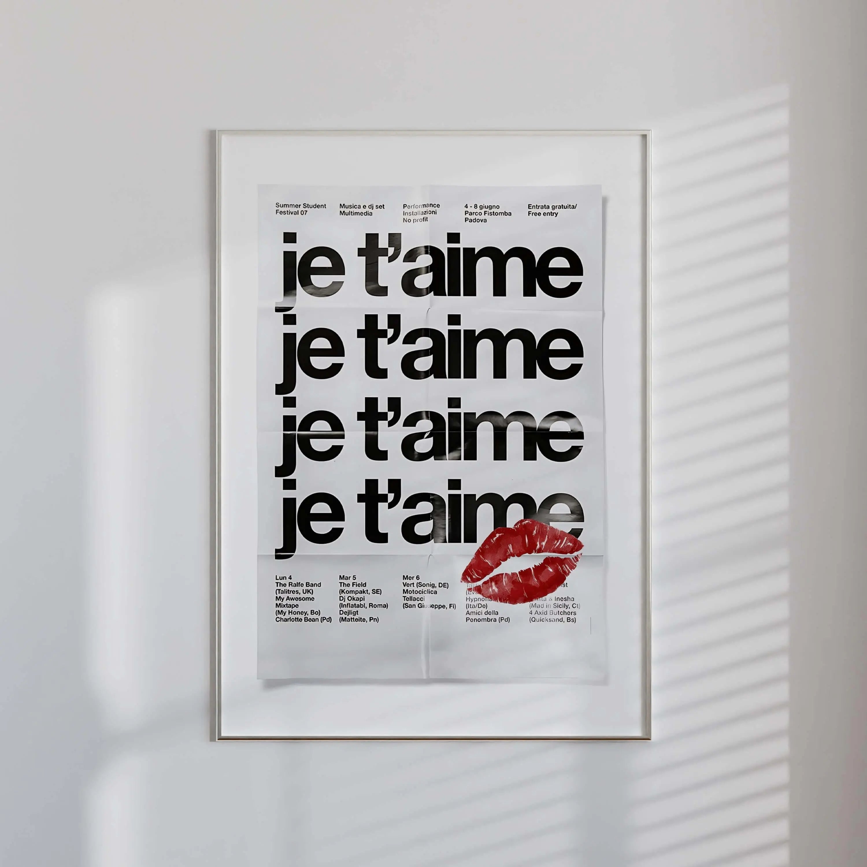 French Quote Poster Room Decor featuring bold black text "je t'aime" repeated with red lips graphic, framed modern wall art in minimalist room, digital wall art by HAUS OF PRINTS