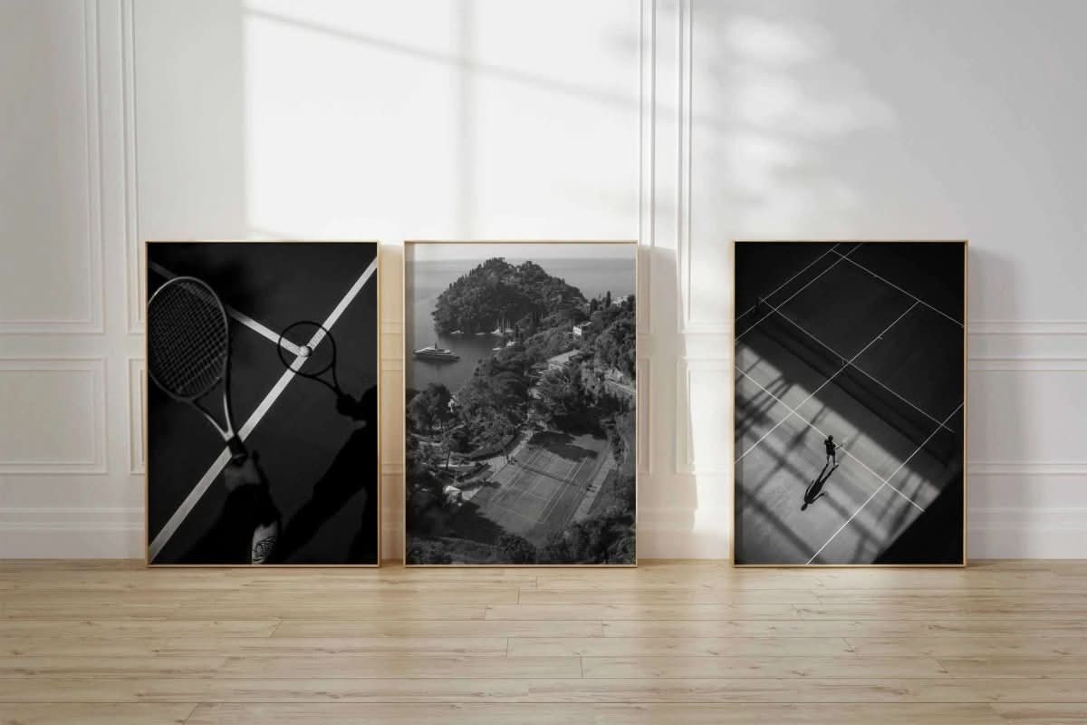 A tennis court perspective with shadows creating dramatic lines across the surface.