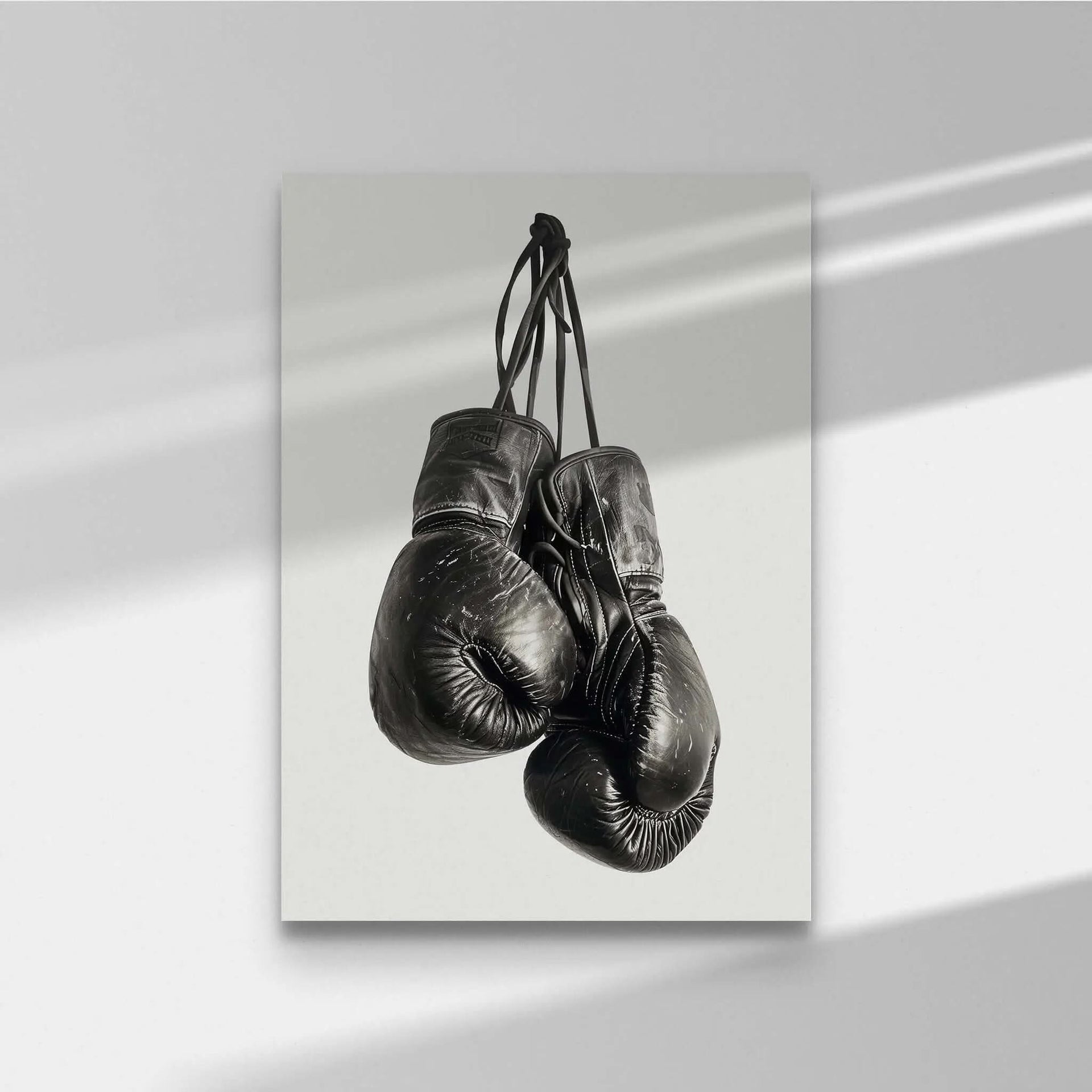 Vintage Boxing Gloves Wall Art featuring two black gloves hanging, perfect for modern decor in any space.
