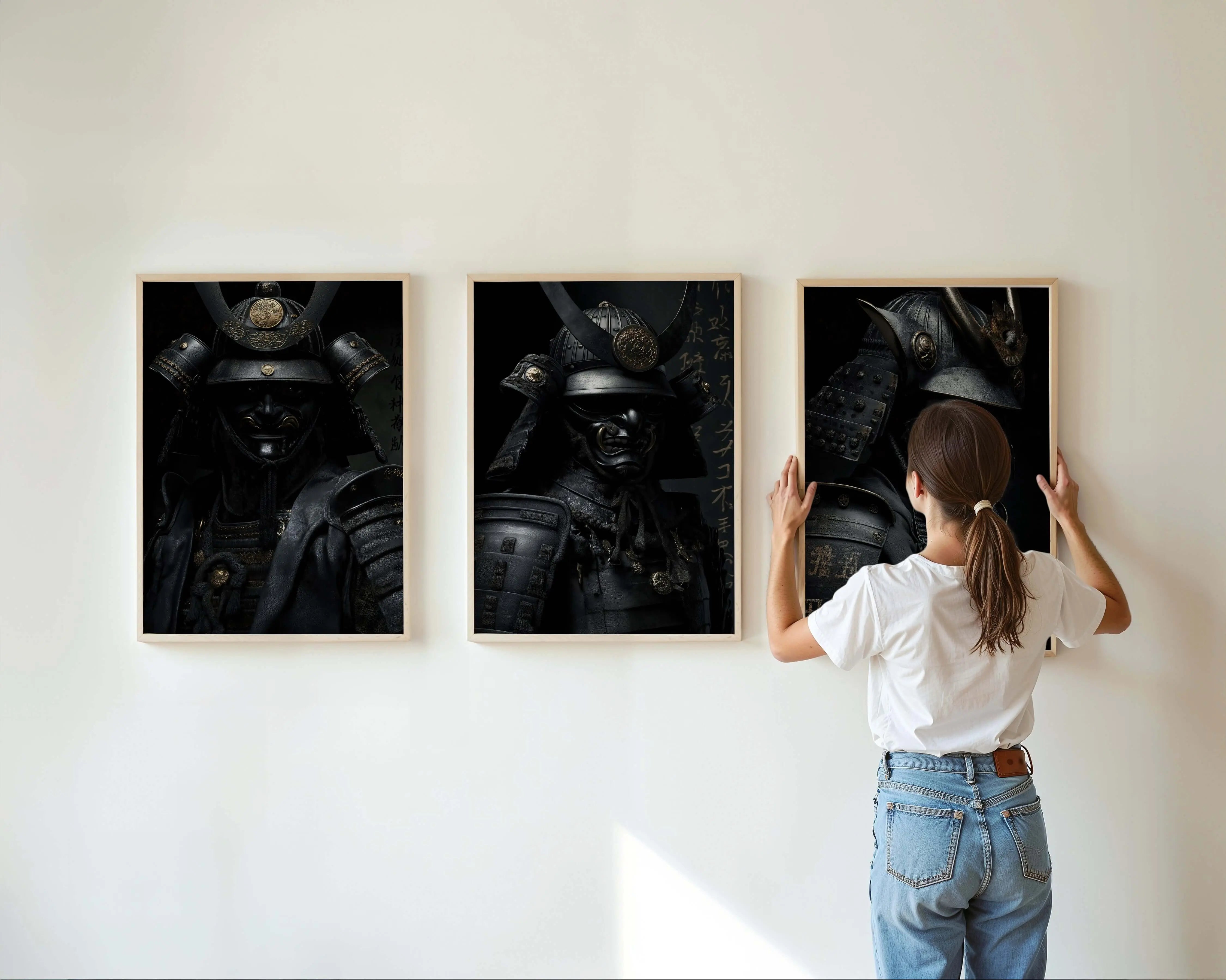 Woman arranging Shadow Honor Triptych Art Prints featuring samurai warriors, modern wall art for home decor.